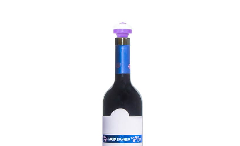Vijolični vakuumski zamašek na steklenici vina na belem ozadju.